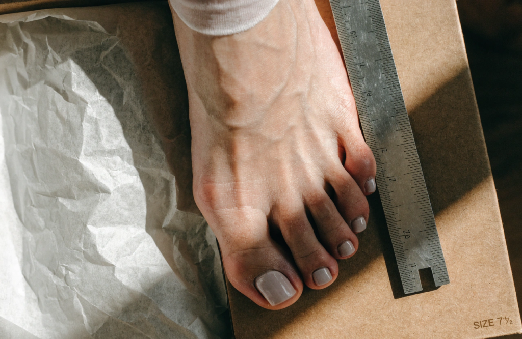 a-close-up-of-a-woman-s-foot-next-to-a-ruler--top-.png