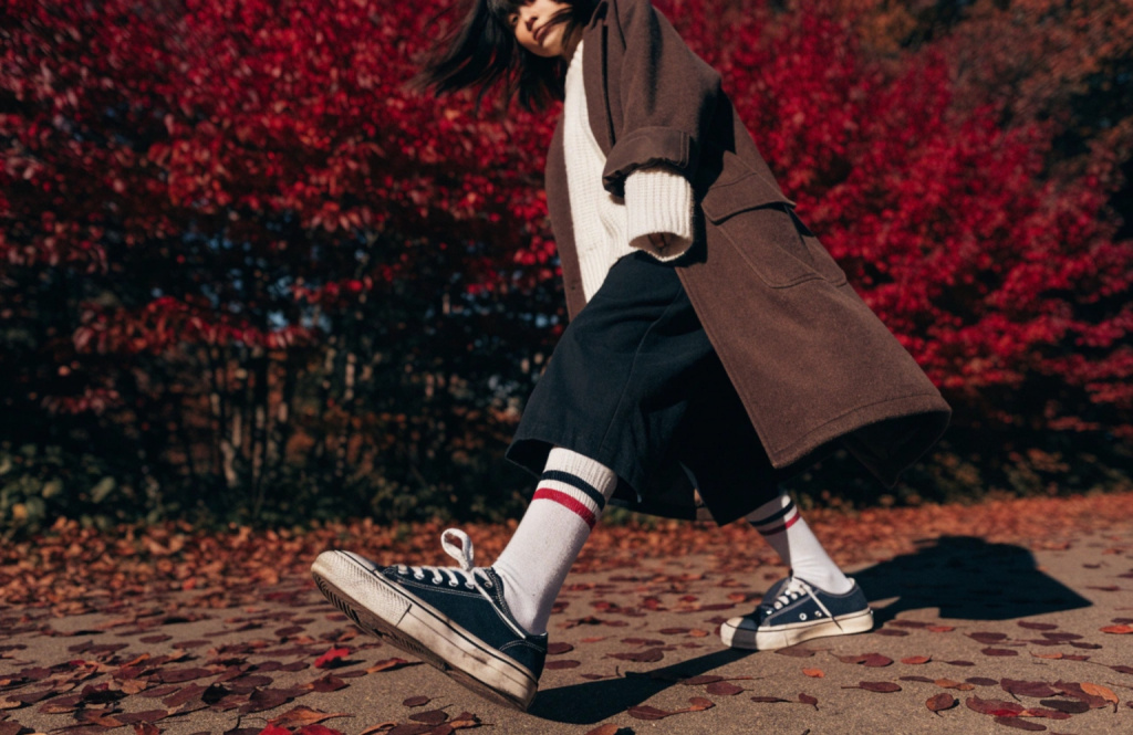 a-girl-in-a-white-sweater-and-a-brown-coat-is-walk.jpg